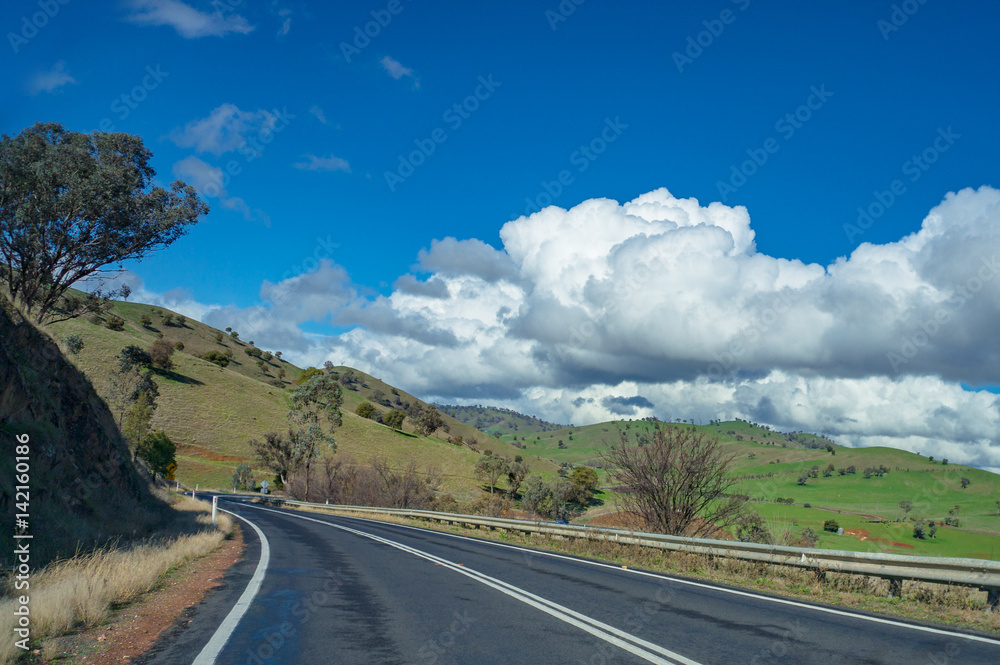 Australian outback road, highway on sunny day. Rural infrastructure concept