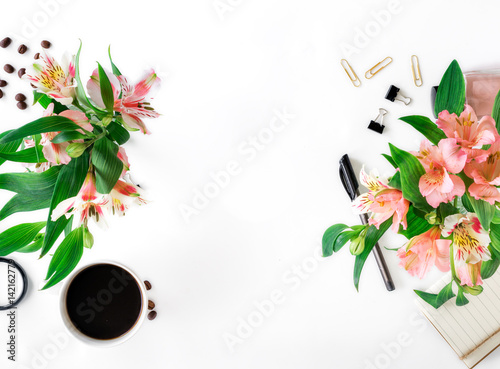 Female workspace with office accessories  coffee and bouquet of flowers