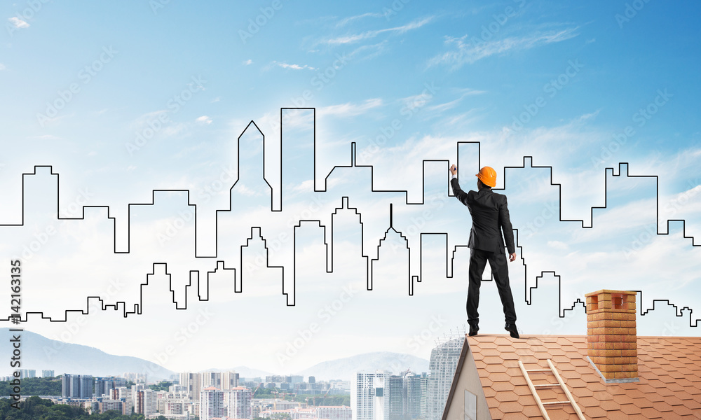 Man architect draw silhouette of modern city on blue sky. Mixed media Man architect draw silhouette of modern city on blue sky. Mixed media