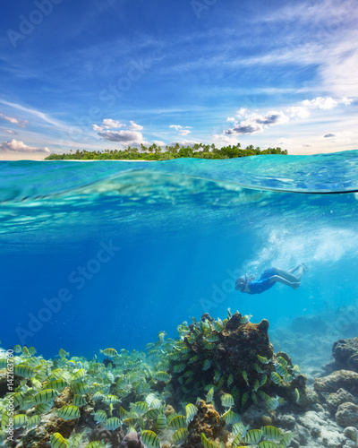 Young woman snorkeling and exploring corals