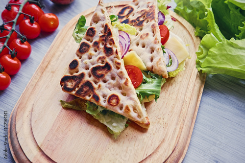 Pita bread with ham, cucumber and tomatoes.