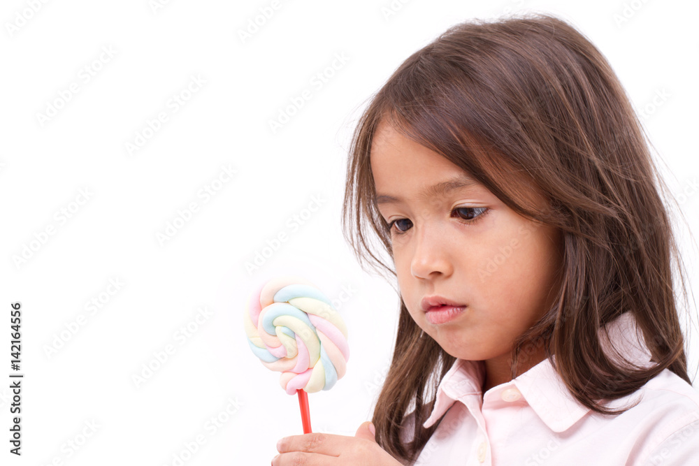 little girl looking at sweet marshmallow candy