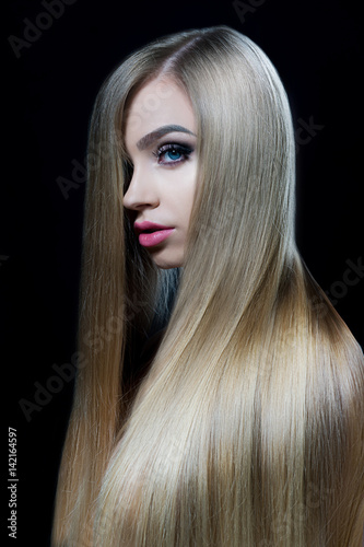 Portrait of a beautiful girl with chic long shiny hair. Perfect shine of hair