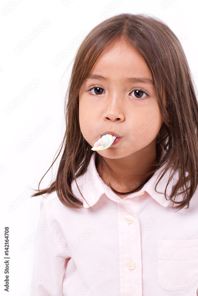 playful, happy, smiling cute little girl eating marshmallow sweet candy playful, happy, smiling cute little girl eating marshmallow sweet candy