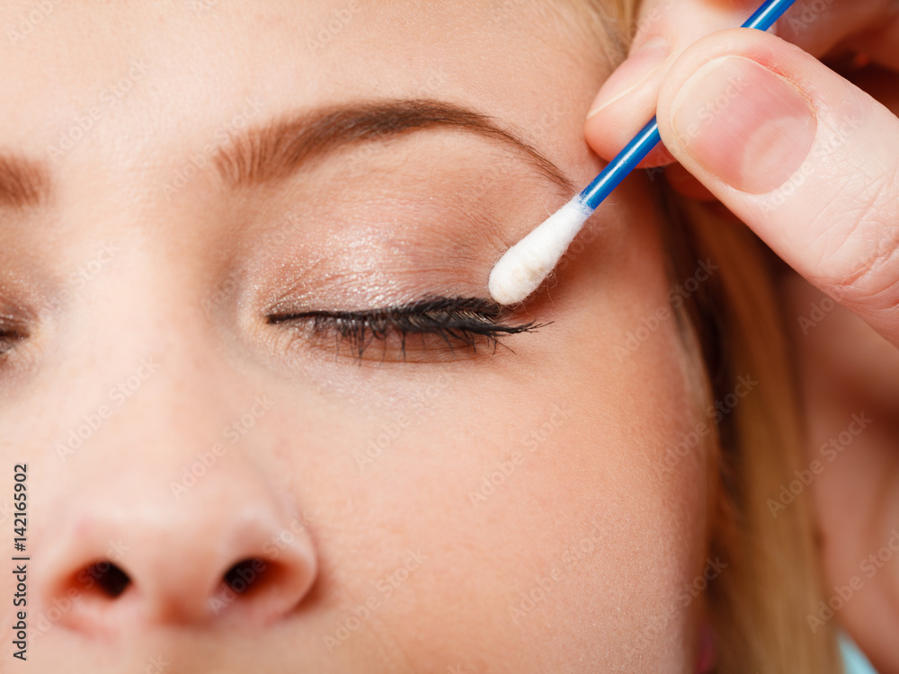 Woman getting her makeup done with cotton buds
