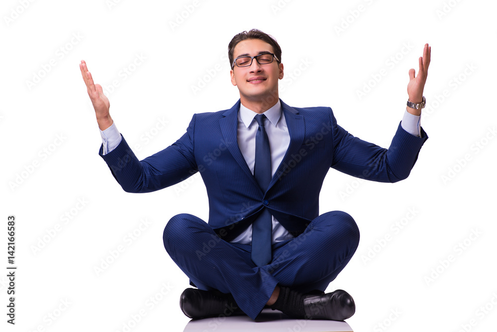 Businessman meditating on the floor isolated on white Businessman meditating on the floor isolated on white