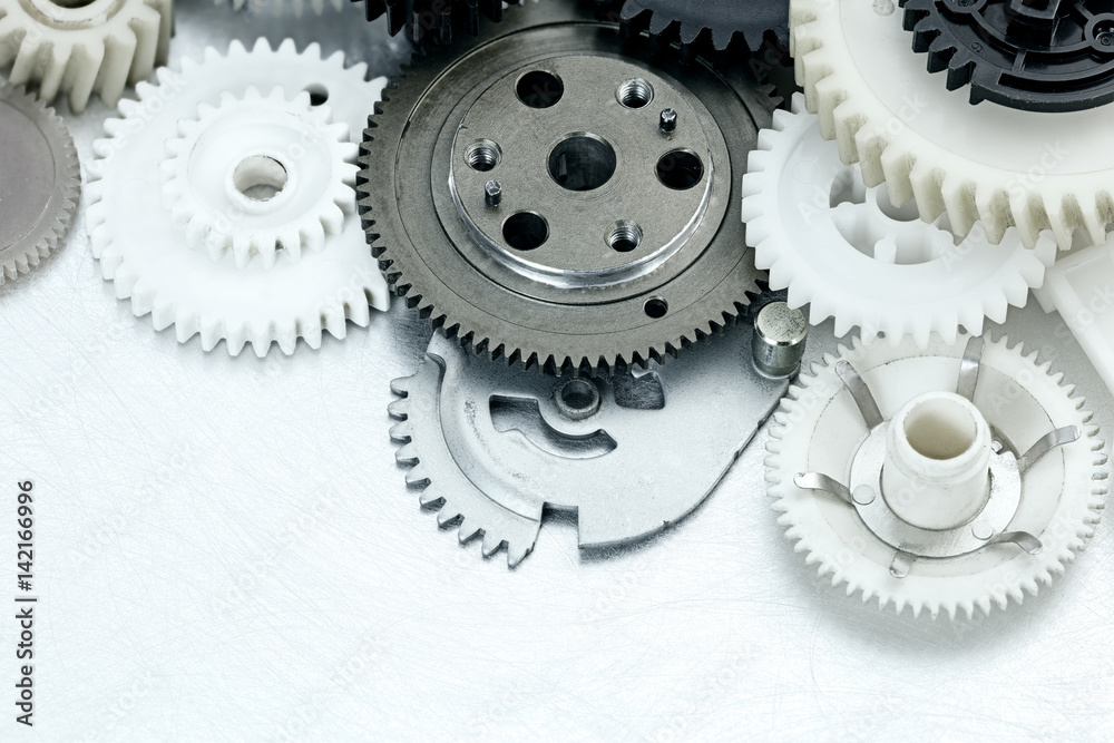 scratched metal industrial background with plastic gears. industrial equipment. scratched metal industrial background with plastic gears. industrial equipment.