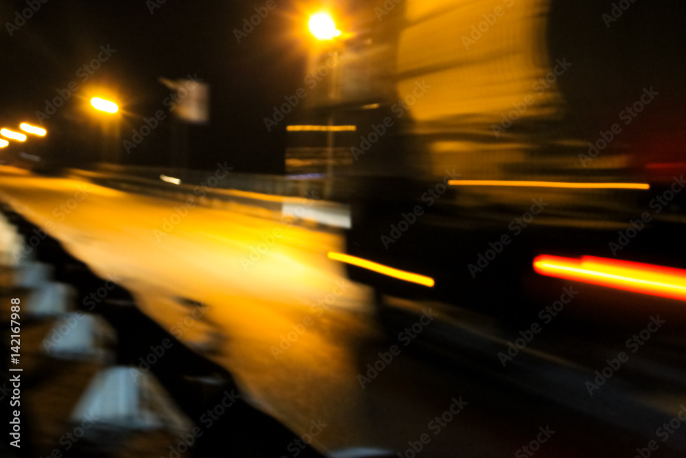 Blurred traffic light trails on road at night