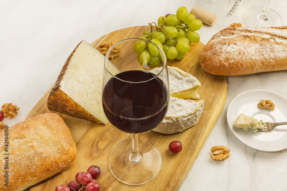 Wine and cheese tasting with bread, grapes and copyspace