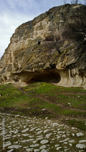 The cave is on a hillside in the ancient town Chufut-Kale in Crimea, near Bakhchisarai. Vertical view