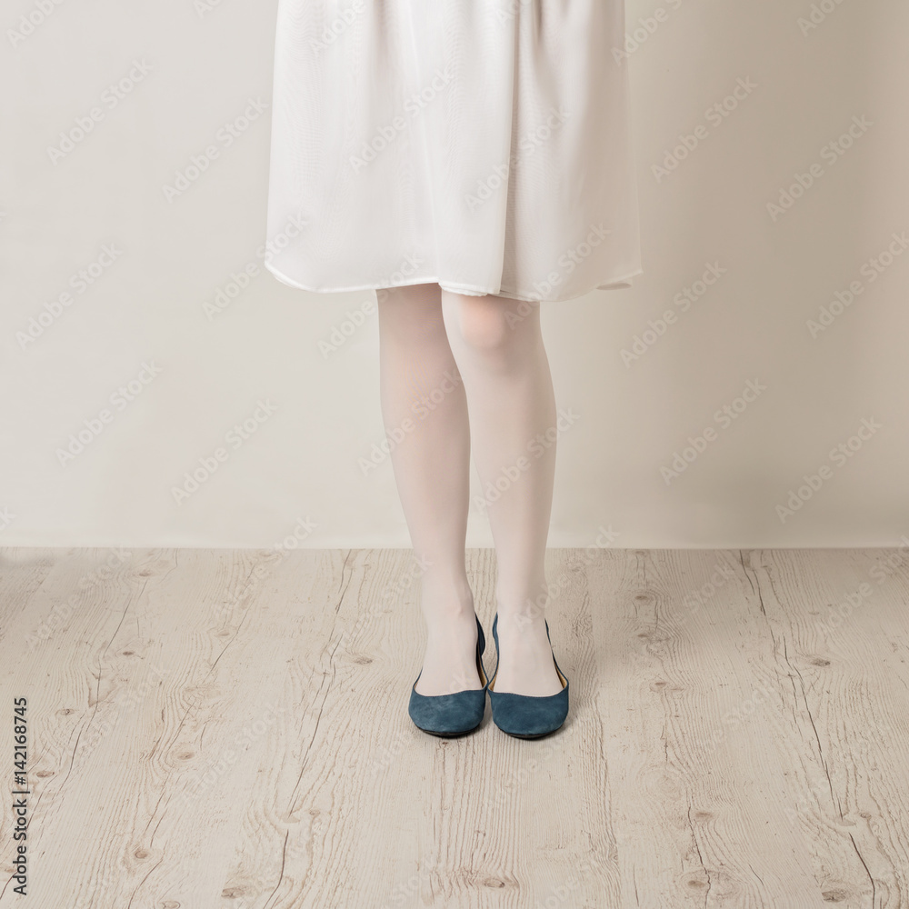 Female Legs In White Tights, Skirt And Ballet Flats On A White Background.  Selective Focus. Stock Photo, Picture and Royalty Free Image. Image  73482943.