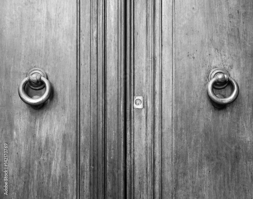 Details of an ancient Italian door, black and white.