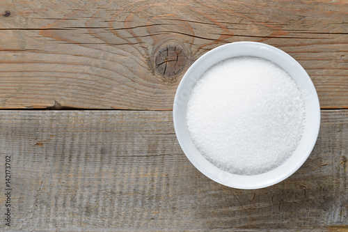 White sugar on wooden table