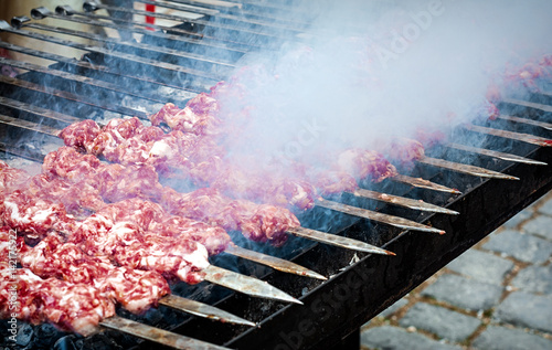 Marinated kebab preparing over charcoal photo