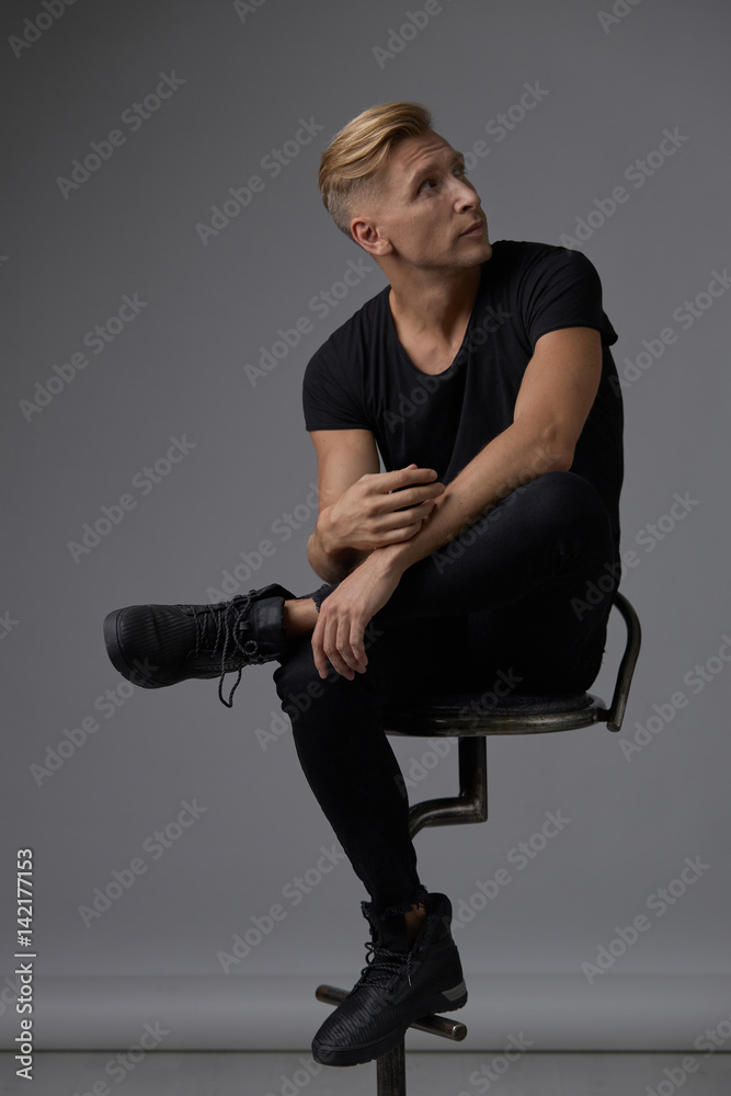 Handsome blond young man posing at studio Handsome blond young man posing at studio