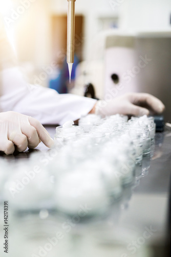 Pharmacy technician hands. Man working with laboratory beakers and glassware.