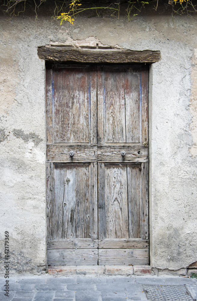 Wooden door in an old Italian house.
