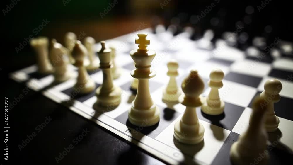 Dolly video of the white pieces on a chess board, with shallow depth of field. Dolly video of the white pieces on a chess board, with shallow depth of field.