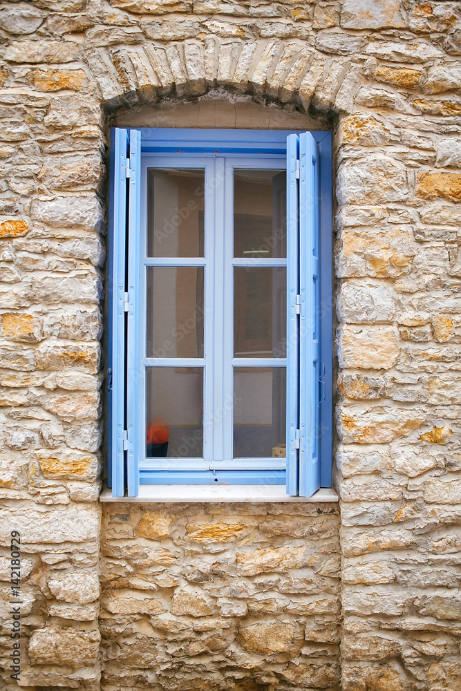 Light blue old window on a stone wall Light blue old window on a stone wall