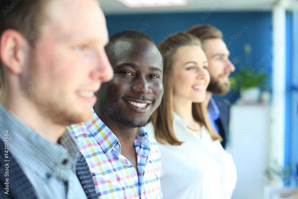 Happy smiling business team standing in a row at office Happy smiling business team standing in a row at office