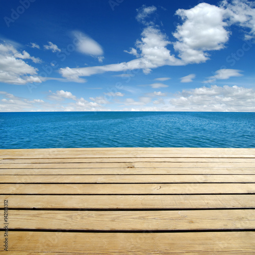 Fototapeta Naklejka Na Ścianę i Meble -  Wood, blue sea and sky