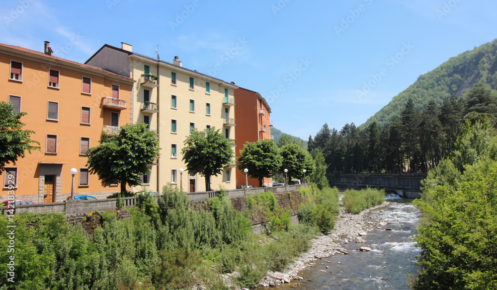 Colored houses on the bank of a stony river,Italy