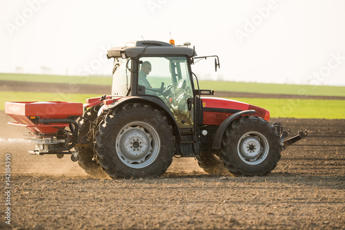 Tractor spreading artificial fertilizers