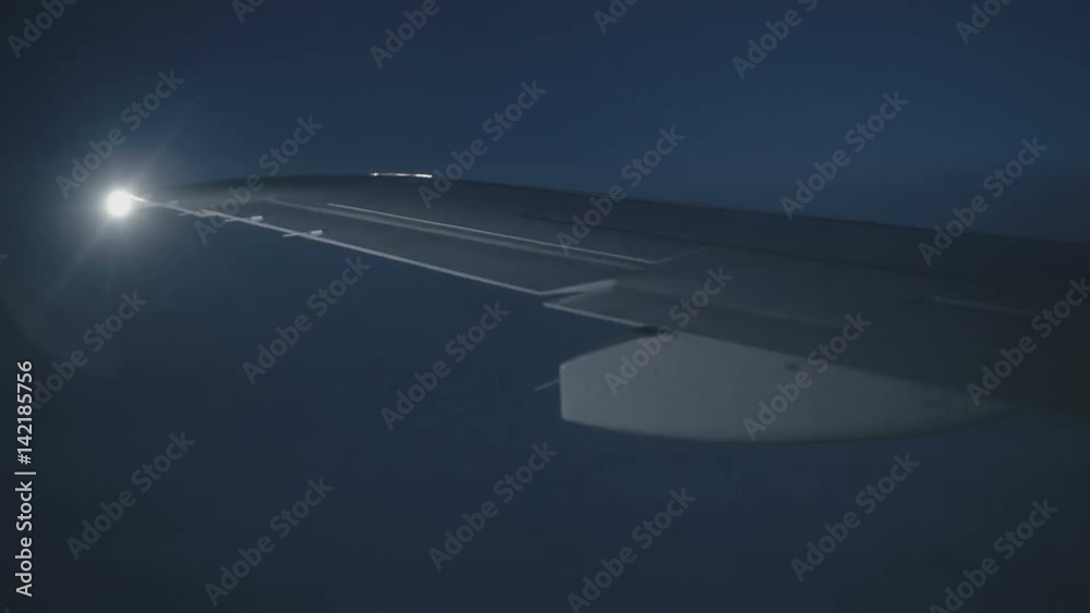 Wing aircraft in the sky with lights in the night view from the window Wing aircraft in the sky with lights in the night view from the window