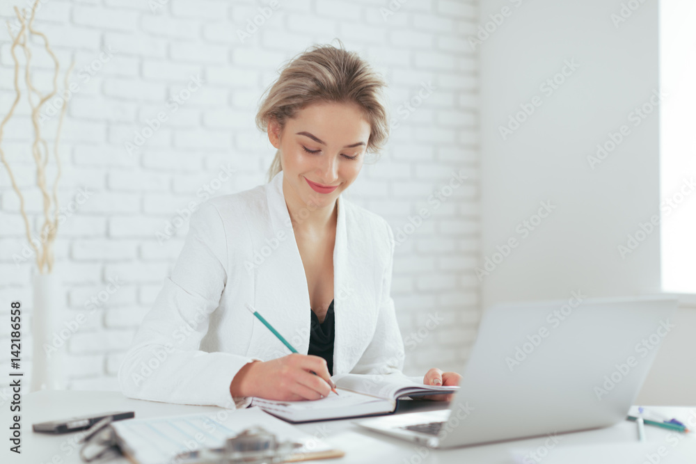 Portrait of beautiful young woman working in the office. Portrait of beautiful young woman working in the office.