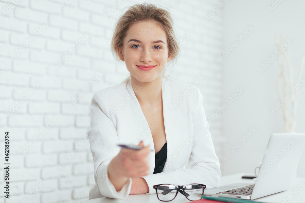 Portrait of beautiful young woman working in the office. Portrait of beautiful young woman working in the office.