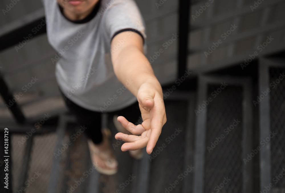 Help concept young woman hand reaching up Help concept young woman hand reaching up