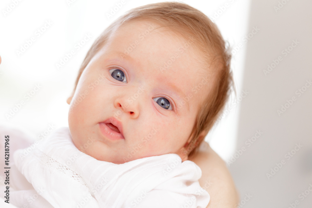 Young mother and newborn baby in white bedroom Young mother and newborn baby in white bedroom