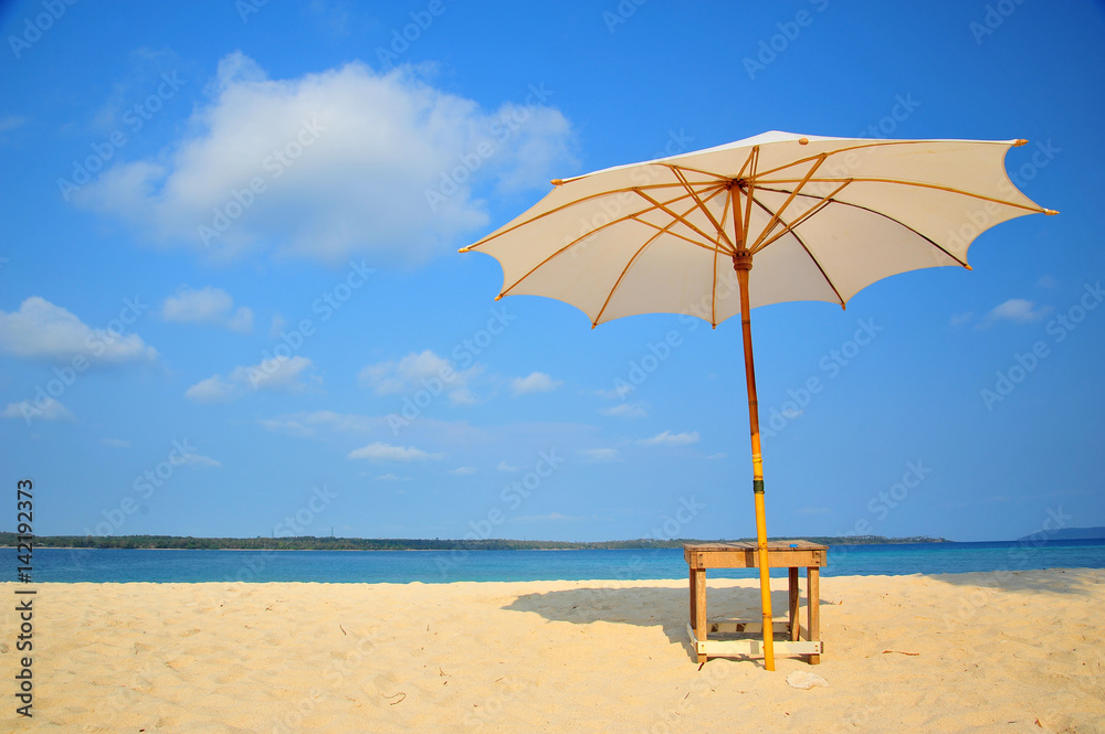 Fototapeta premium White Sand Beach with Beach Umbrella in Summer Season