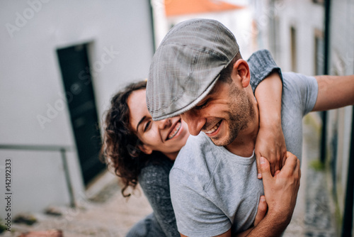 Couple has fun and laughs. kiss. Young hipster couple hugging each other in city. Kove story, a beautiful stylish young couple. Fashion concept with boyfriend and girlfriend in Lisboa