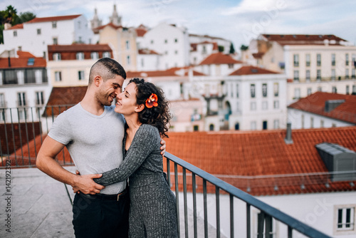 Couple has fun and laughs. kiss. Young hipster couple hugging each other in city. Kove story, a beautiful stylish young couple. Fashion concept with boyfriend and girlfriend in Lisboa photo