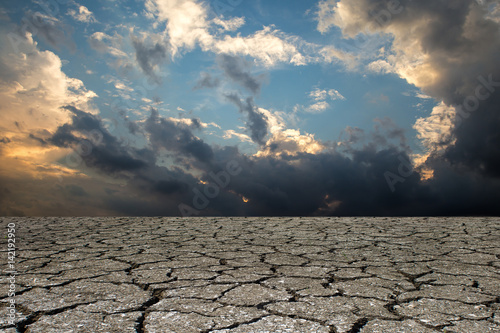 Dry cracked ground filling the frame as sky background