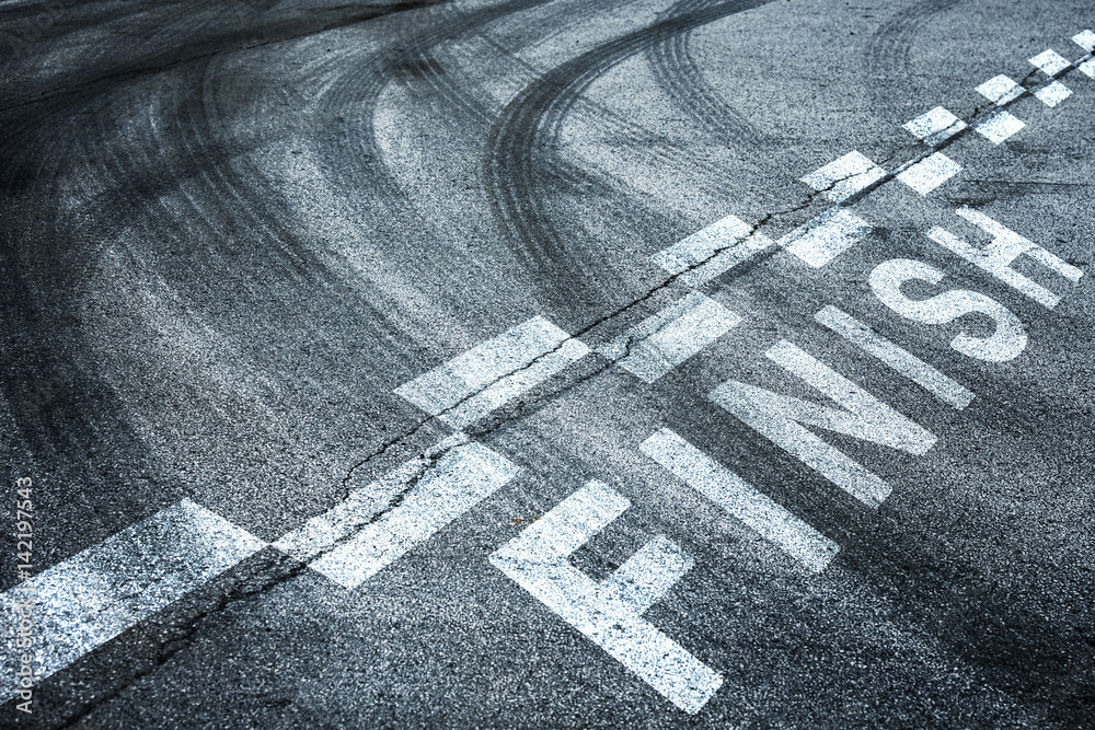Race finish line pattern background on the asphalt floor with crossing