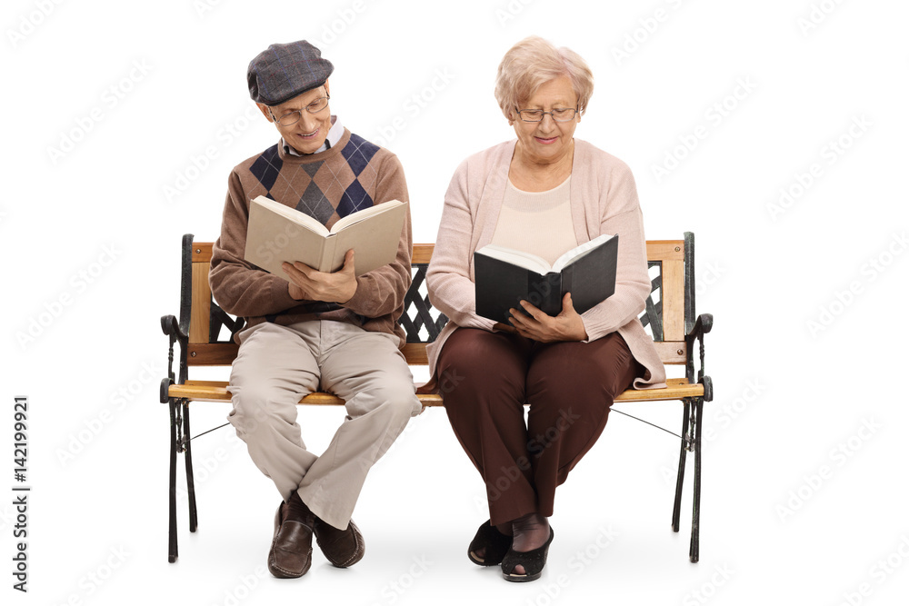 Seniors sitting on a bench and reading books Seniors sitting on a bench and reading books