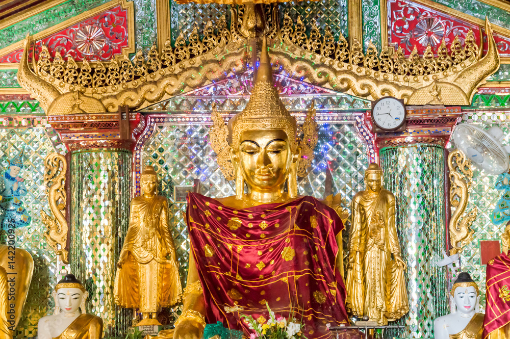 Golden Buddha statue inside Shwedagon Pagoda in Yangon, Burma Myanmar