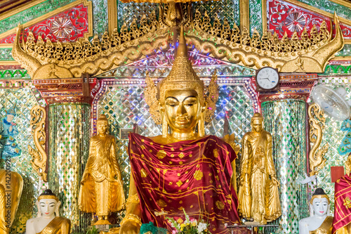 Golden Buddha statue inside Shwedagon Pagoda in Yangon, Burma Myanmar