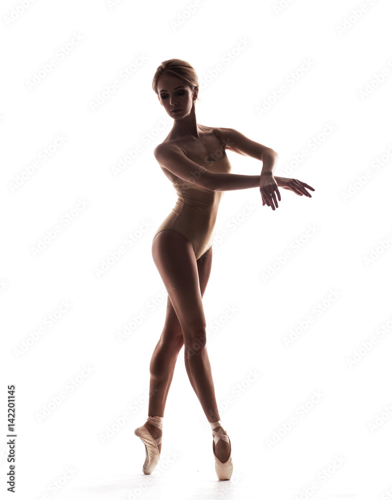 Ballerina in black outfit posing on toes. isolated on white studio background. Ballerina in black outfit posing on toes. isolated on white studio background.