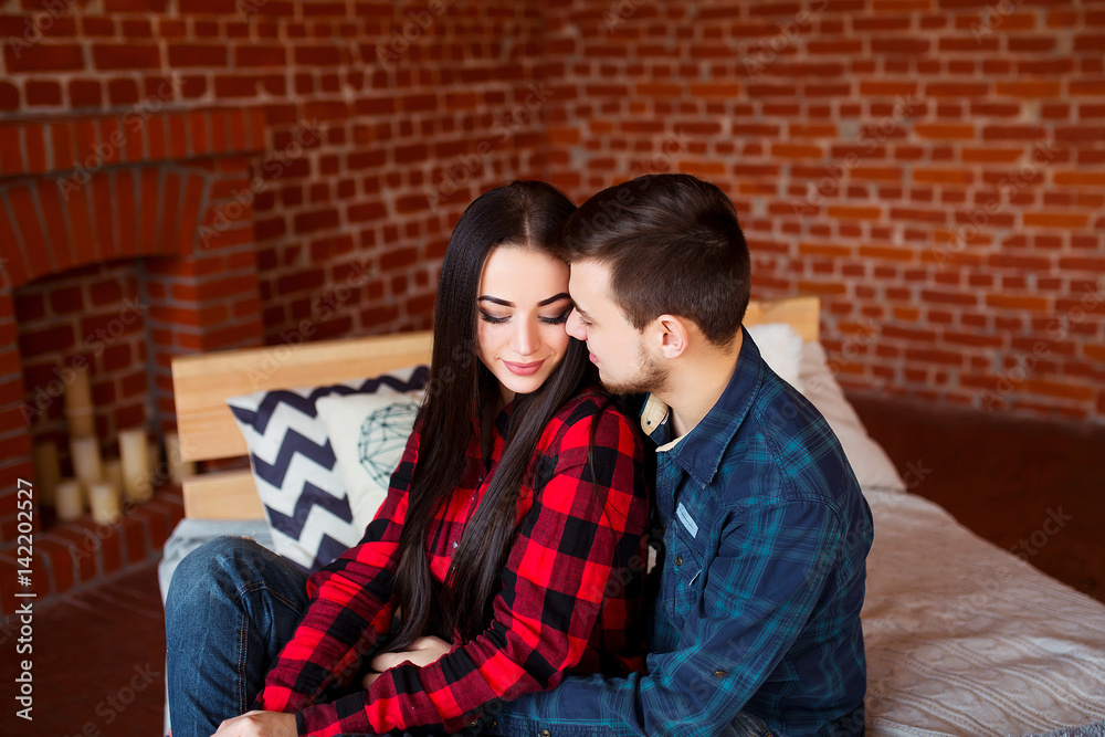 Beautiful couple having great time and hugging at home. Young man and woman enjoy relationship together. Beautiful couple having great time and hugging at home. Young man and woman enjoy relationship together.