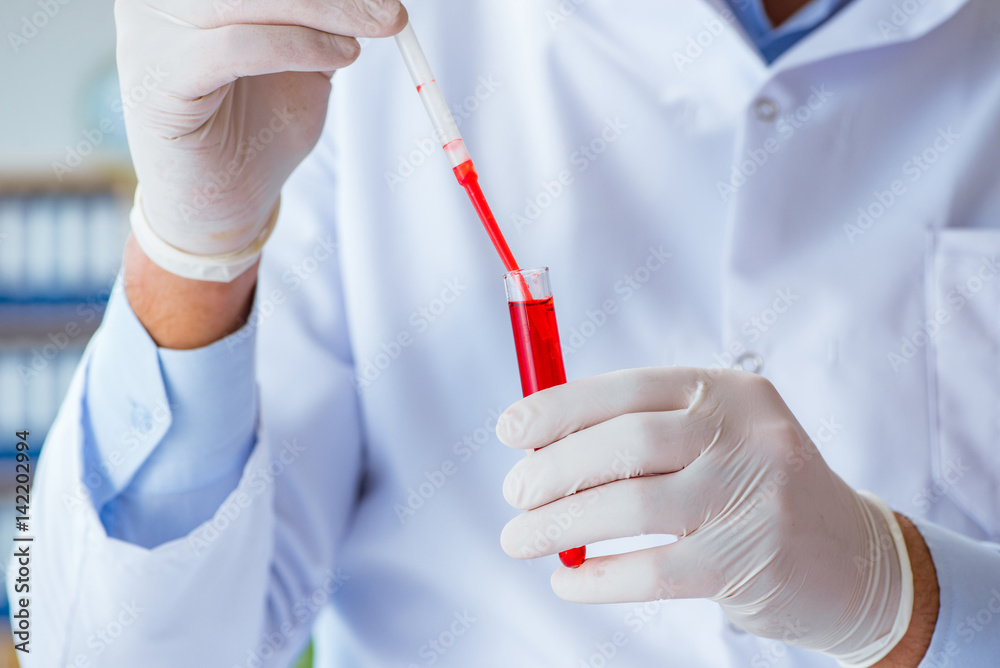 Young doctor working on blood test in lab hospital Young doctor working on blood test in lab hospital