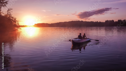 Romantic golden sunset river lake fog loving couple small rowing boat date beautiful Lovers ride during Happy woman man together relaxing water nature around