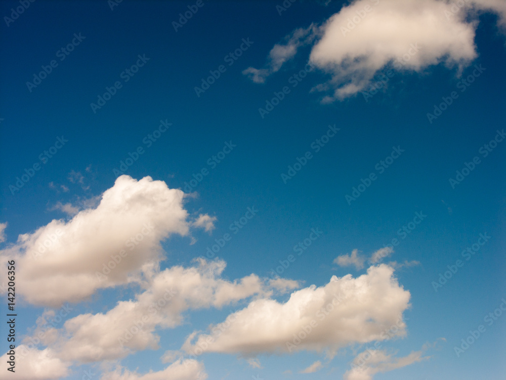 White Clouds in Blue skies Over Green Fields