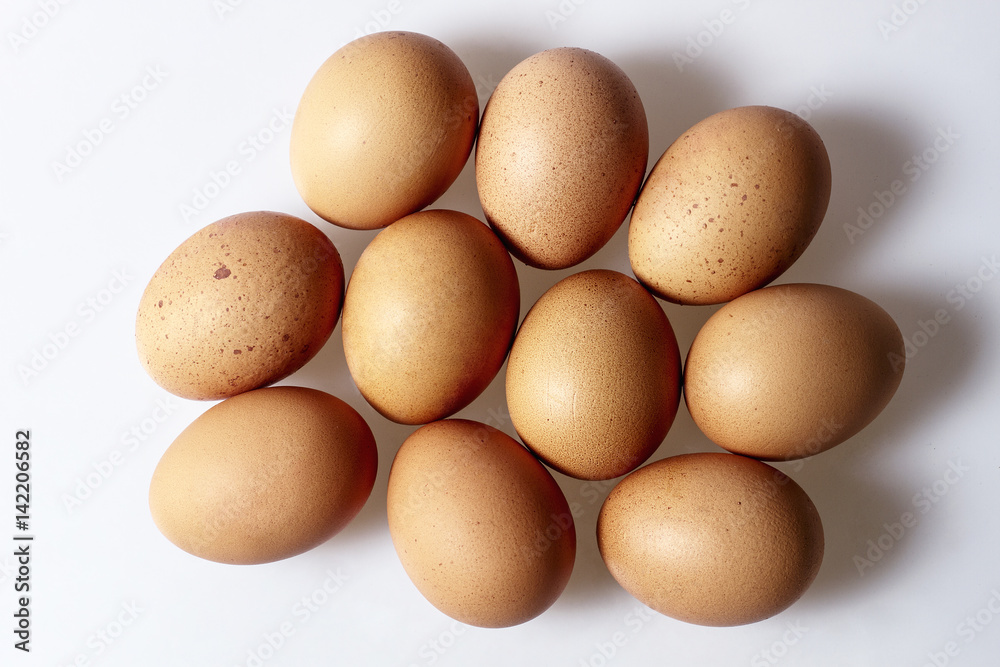 Chicken eggs on white background, view from top Chicken eggs on white background, view from top