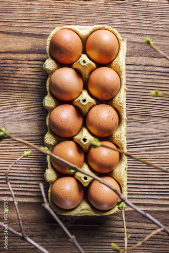 Organic eggs on a wooden table, view from top