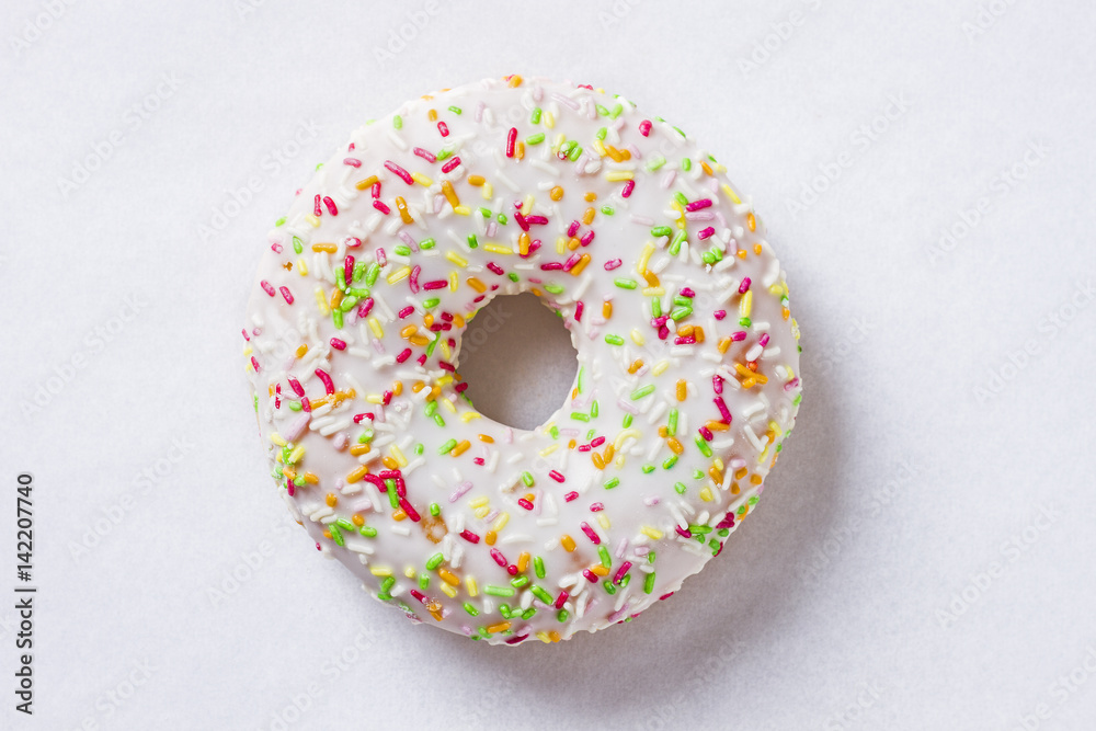 Donut with colorful sprinkles isolated on white