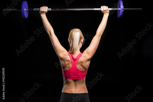 woman exercising with barbell