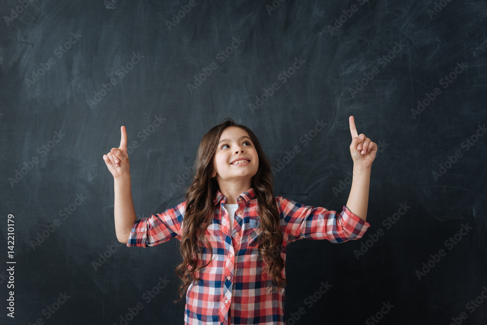Glad girl demonstrating imaginary drawing in the studio Glad girl demonstrating imaginary drawing in the studio